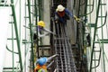 Asian people worker knitting metal rods bars into framework reinforcement for concrete pouring at construction site