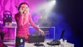 Asian performer playing electronic sound using mixer console Royalty Free Stock Photo