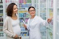 asian pharmacist in glasses holding clipboard