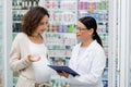 asian pharmacist in glasses writing on