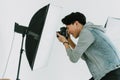 Asian Photographer shooting with model in Studio