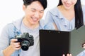 Asian Photographer and model looking pictures from camera Royalty Free Stock Photo