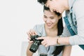Asian Photographer and model looking pictures from back screen of camera Royalty Free Stock Photo