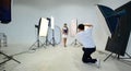 An Asian photographer is photographing a model posing in the studio Royalty Free Stock Photo