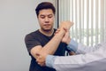 Asian physiotherapists check the elbows of patients who have undergone orthopedic rehabilitation Royalty Free Stock Photo