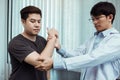 Asian physiotherapists check the elbows of patients who have undergone orthopedic rehabilitation Royalty Free Stock Photo