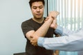 Asian physiotherapists check the elbows of patients who have undergone orthopedic rehabilitation