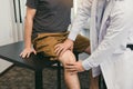 Asian physiotherapists are checking patients` knees Royalty Free Stock Photo