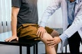 Asian physiotherapists are checking patients` knees Royalty Free Stock Photo