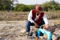 Asian plumber is checking blue pipe of water supply in garden. Royalty Free Stock Photo