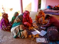Asian poor women repaying loan installment on microfinance bank in india January 2020