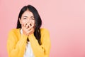 Woman standing amazed, shocked afraid mouth covered gesturing hand palms looking camera Royalty Free Stock Photo