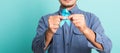 Handsome man posing he holding light blue ribbon for supporting people living Royalty Free Stock Photo