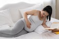 Asian pregnant are reading a book in bedroom,pregancy concept Royalty Free Stock Photo