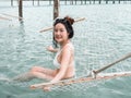 Asian pregnant woman in bikini sitting on hammock in turquoise sea water near beach. tropical beach in Koh Kut Island, Thailand. p Royalty Free Stock Photo