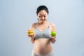 Asian pregnant woman choose healthy food or junk food