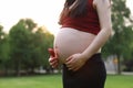 Asian pregnant woman in garden forest lawn outdoor nature free relax happy sunshine shape of love on hands