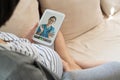 Asian pregnant woman having online video call with obstetrician on digital tablet at home Royalty Free Stock Photo