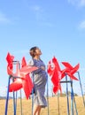 Asian pregnant woman in the middle of red pinwheel Royalty Free Stock Photo