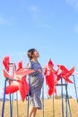 Asian pregnant woman in the middle of red pinwheel Royalty Free Stock Photo