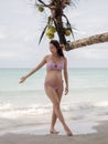 Asian pregnant woman posture on tropical sand beach with palm tree in sunny day in Thailand. Pregnancy relaxation from depression Royalty Free Stock Photo