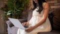 Asian pregnant woman using computer laptop at home Royalty Free Stock Photo
