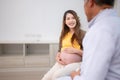 Asian pregnant woman visit gynecologist doctor at medical clinic for pregnancy consultant.