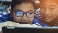 Asian preteens watching on tablet computer , smile face.
