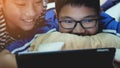 Asian preteens watching on tablet computer , smile face. Royalty Free Stock Photo