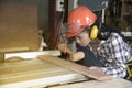 Asian pretty female carpenter using wood hammer. Royalty Free Stock Photo