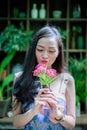 Asian pretty girl has relaxing with happy and smiling at Little Tree Garden cafe, Nakhon Pathom province, Thailand in the morning Royalty Free Stock Photo