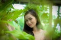 Asian pretty girl has relaxing with happy and smiling at Little Tree Garden cafe, Nakhon Pathom province, Thailand in the morning Royalty Free Stock Photo