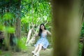 Asian pretty girl has relaxing with swing at Little Tree Garden Royalty Free Stock Photo