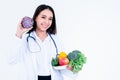 nutritionist holding and showing many fresh vegetables and fruit