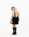 Asian primary school student kid in uniform with yellow backpack. Back to school concept Royalty Free Stock Photo