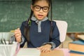 Asian primary school student studying homework in classroom. Royalty Free Stock Photo