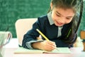 Asian primary school student studying homework in classroom Royalty Free Stock Photo