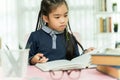 Asian primary school student studying homework in classroom. Royalty Free Stock Photo