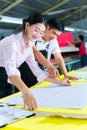 Asian production manager and designer in factory Royalty Free Stock Photo