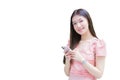 Asian professional business woman with long hair is smiling in the garden while looking at the smartphone in herhand isolated on Royalty Free Stock Photo