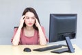 Asian professional business woman who wears pink dress is working tired and feeling headache while she works. There are many Royalty Free Stock Photo