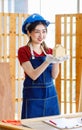 Asian professional female engineer architect foreman labor worker wears safety hard helmet jeans apron and gloves standing smiling Royalty Free Stock Photo