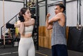 Asian professional muscular male personal trainer teaching female model fit strong body sporty athletic fitness model in sport bra Royalty Free Stock Photo