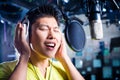 Asian male singer producing song in recording studio Royalty Free Stock Photo