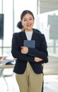 Asian professional successful female businesswoman entrepreneur manager ceo in formal business suit smiling standing posing Royalty Free Stock Photo