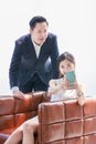 Asian professional successful female businesswoman secretary employee showing calling online mobile phone to male businessman Royalty Free Stock Photo