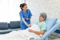 Asian professional successful female internship nurse in blue uniform with stethoscope visiting old senior elderly pensioner woman Royalty Free Stock Photo