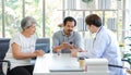 Asian professional successful male doctor in white lab coat with stethoscope hold medicine pill bottle showing explaining dosage