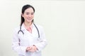 Asian professional woman doctor in a medical uniform is standing smiling Holding hands with white background. New normal and Royalty Free Stock Photo