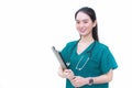 Asian professional woman doctor standing smiling in a green lab shirt, holding patient documents in hand. Health care concept Royalty Free Stock Photo
